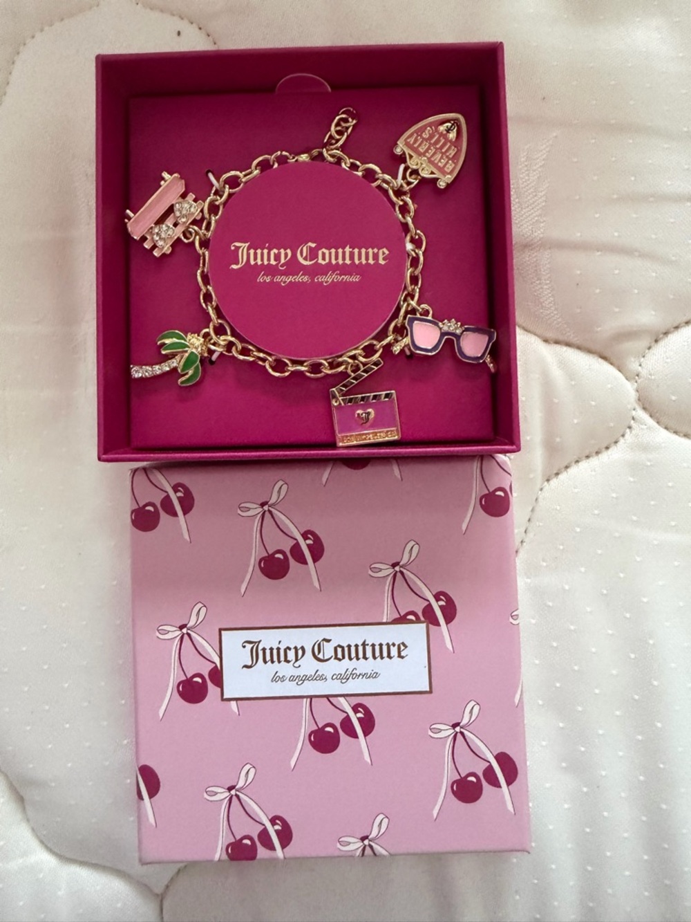 Juicy Couture Gold Charm Bracelet with Pink Accents and Green Leaf Charm